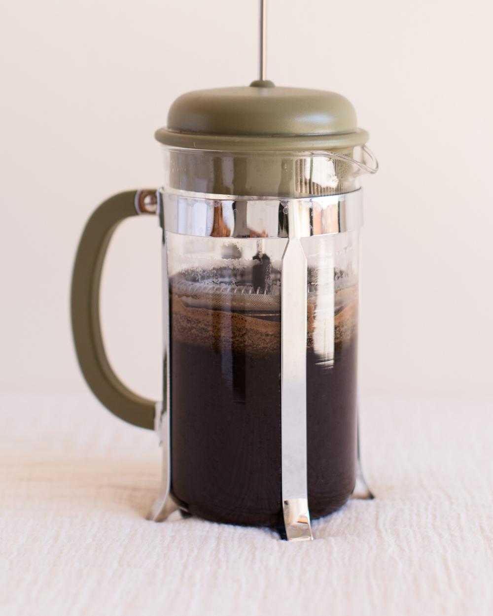 Kalba ground coffee brewing in a French press
